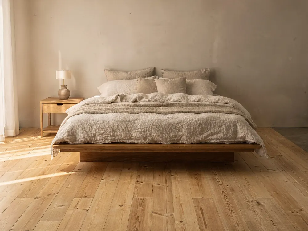 A bedroom with a cream wool rug at different sizes: No rug