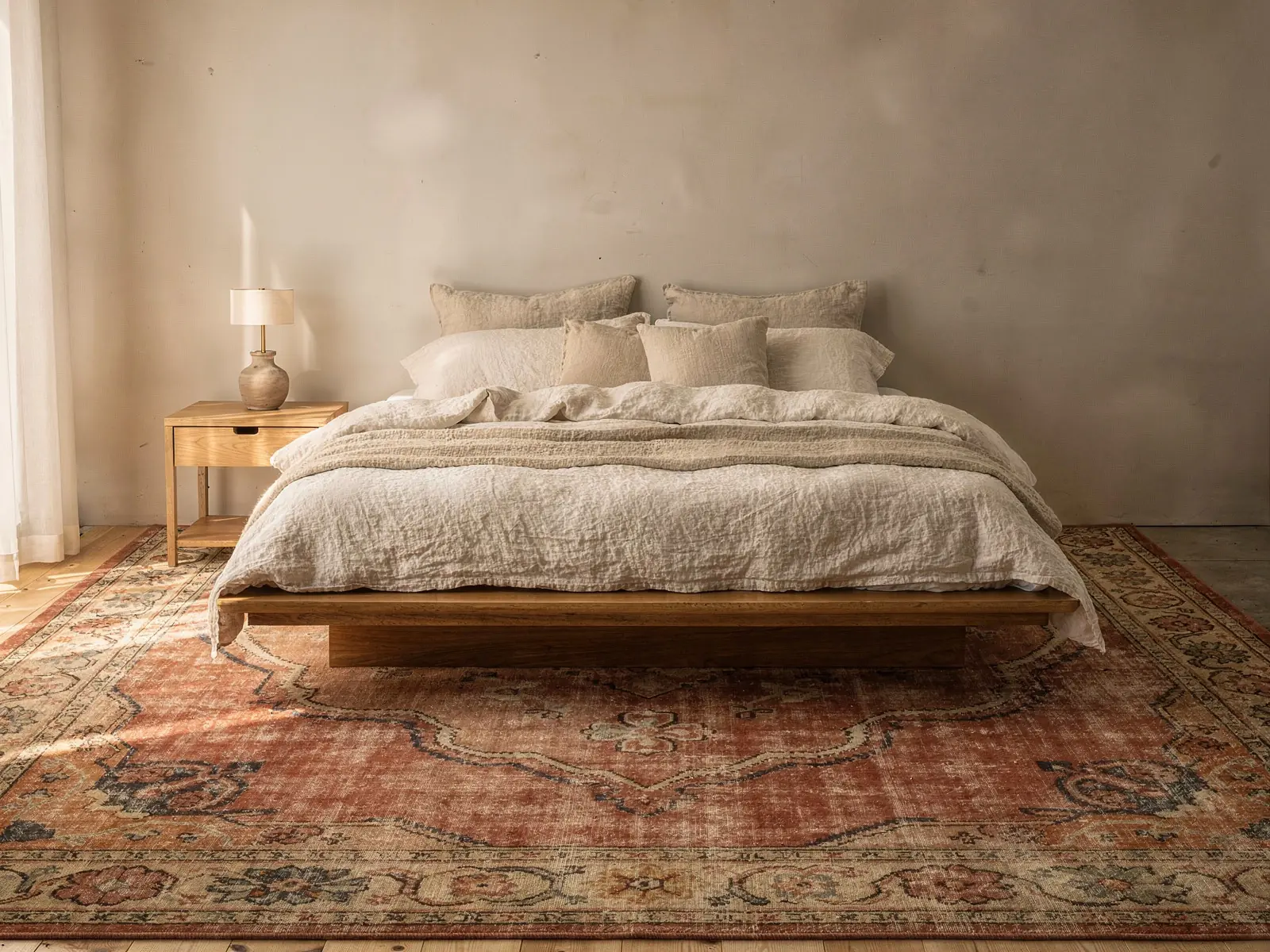 A bedroom with a rug under the bed: Medallion