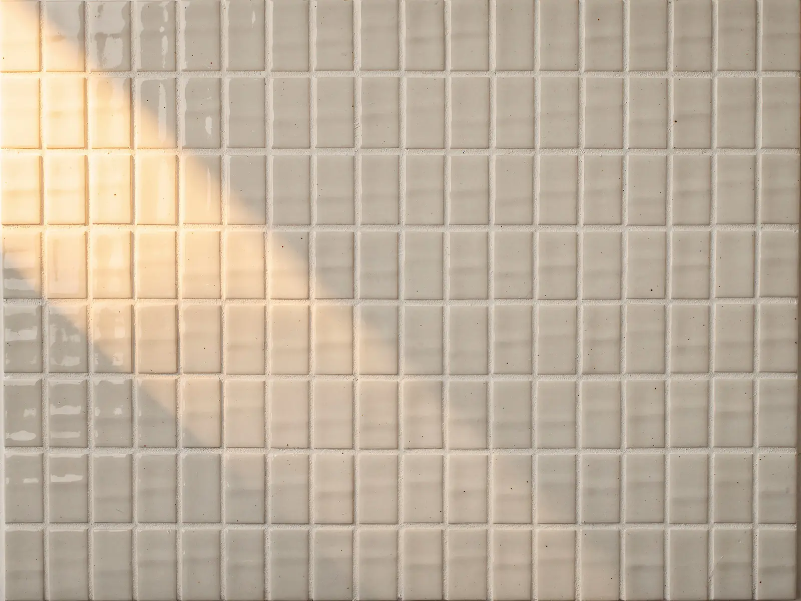 A wall of square ceramic tiles: Bright white